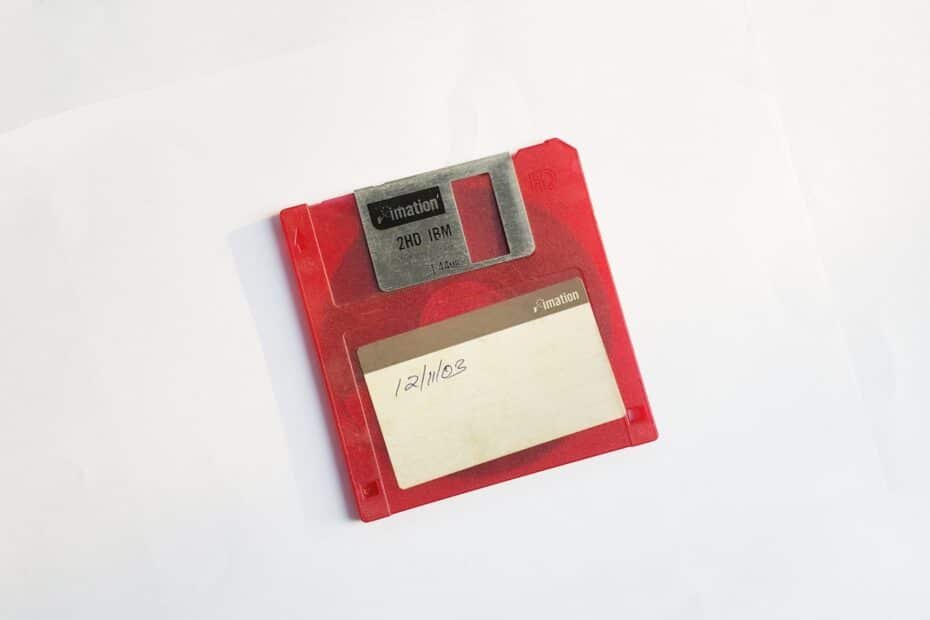 Vibrant red floppy disk symbolizes early computing nostalgia and the evolution of data storage.