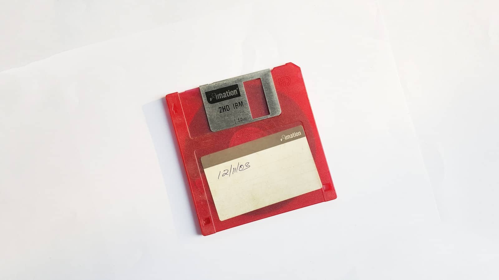 Vibrant red floppy disk symbolizes early computing nostalgia and the evolution of data storage.