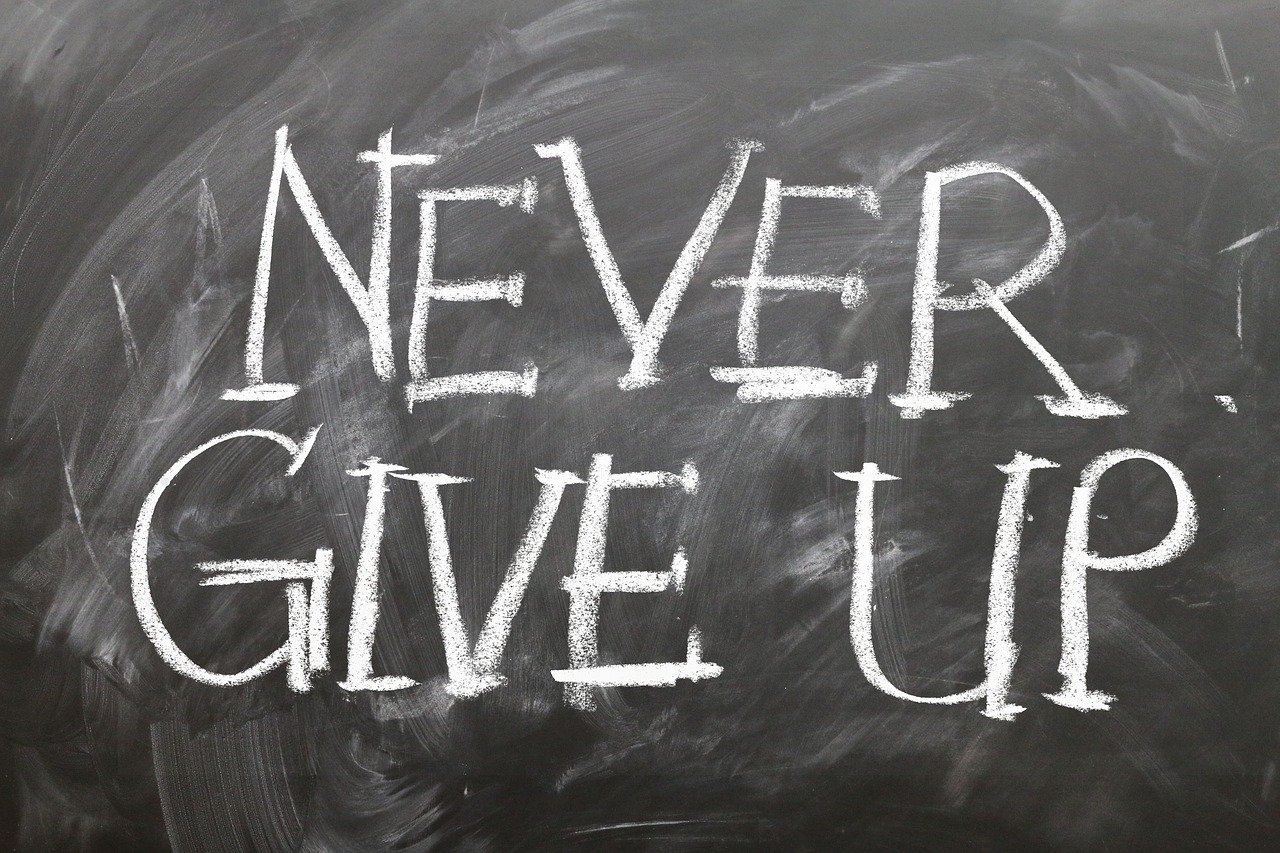 Motivational chalkboard message: never give up inspires resilience and determination.