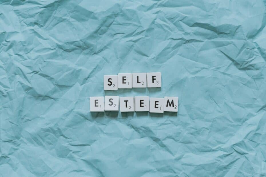 Self-esteem tiles on calming blue paper, inviting reflection on personal worth and acceptance.