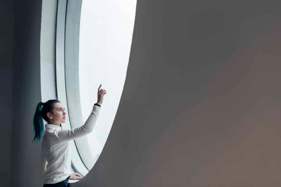 Girl using touch screen in a modern smart home