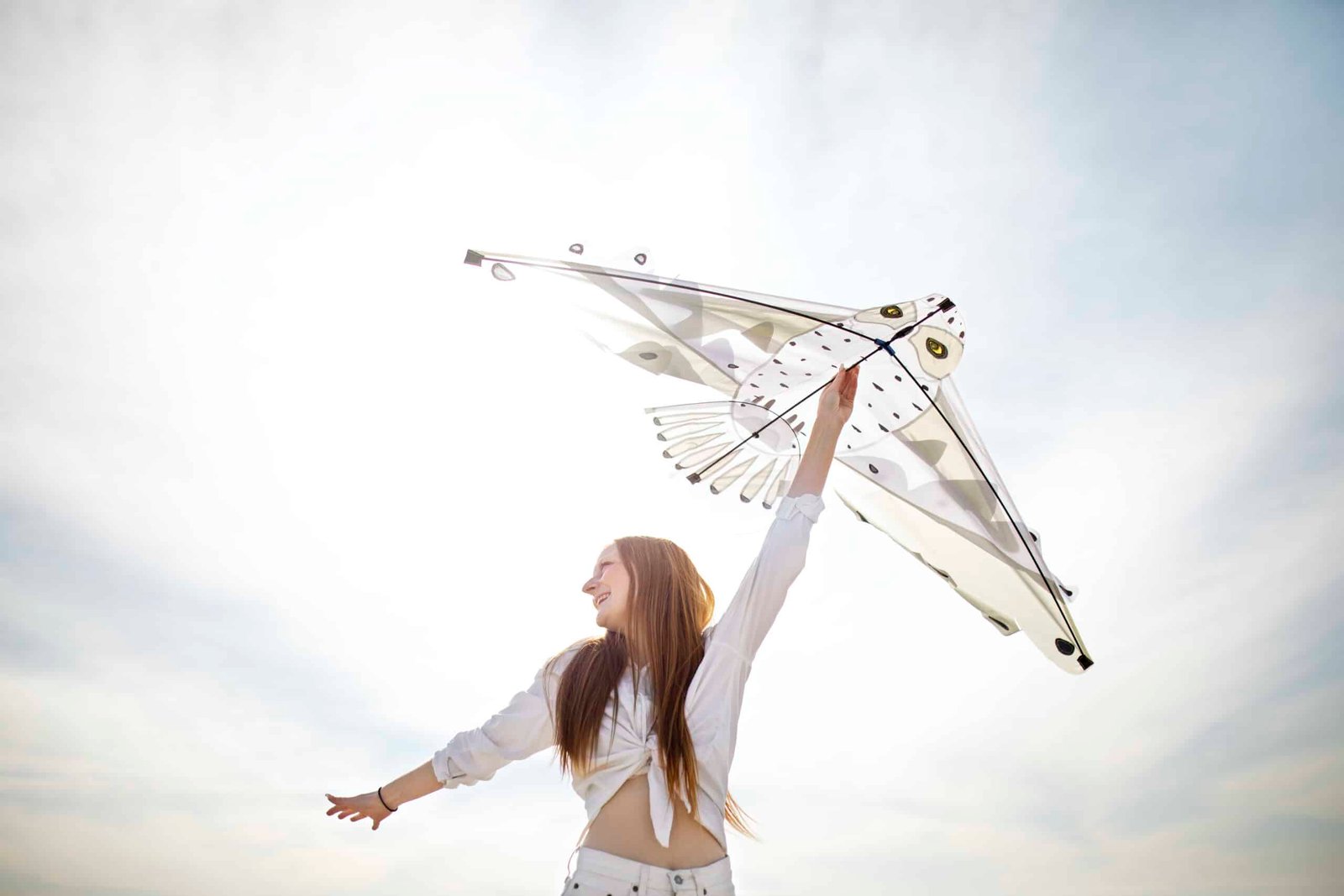 Young adult having fun with kite