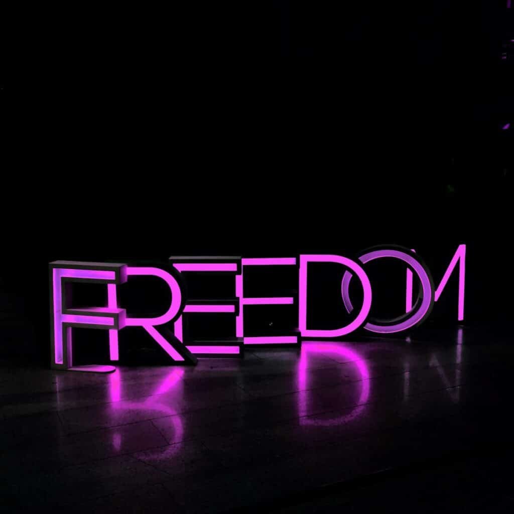 Purple freedom lighted freestanding letters on brown surface