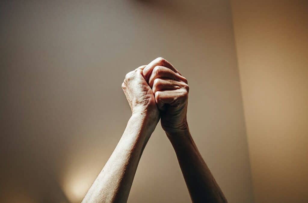 Persons hand on white wall