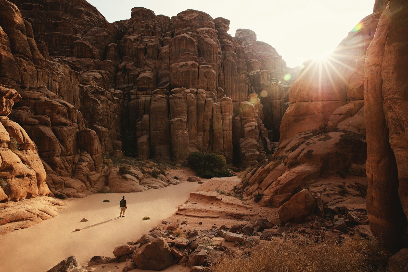 A person standing in a canyon surrounded by rocks