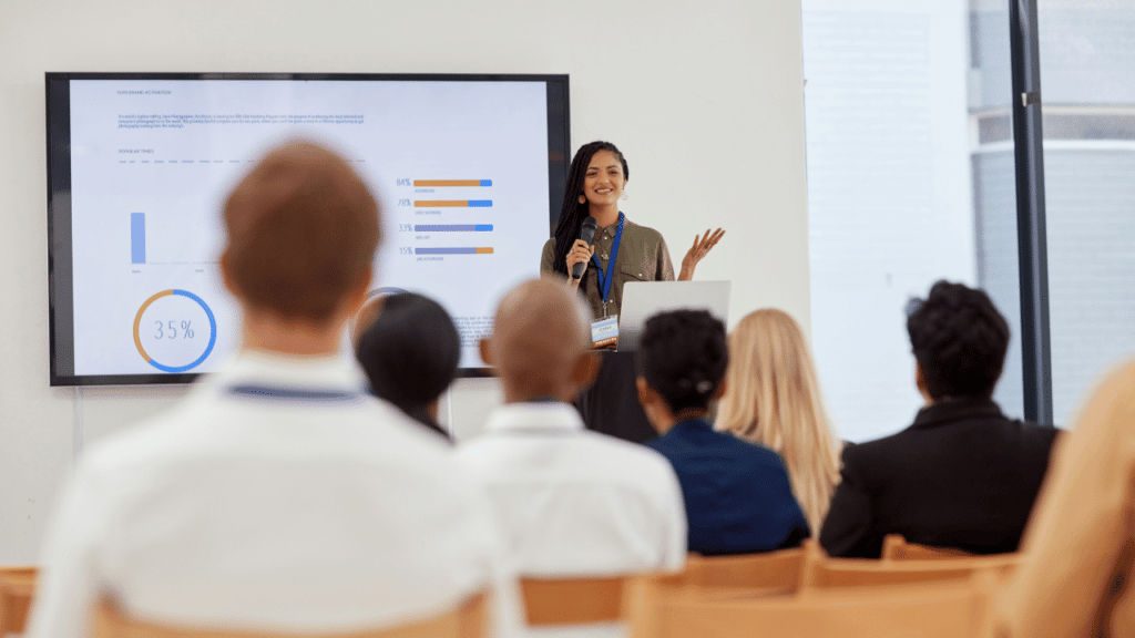 A woman standing in front of a screen