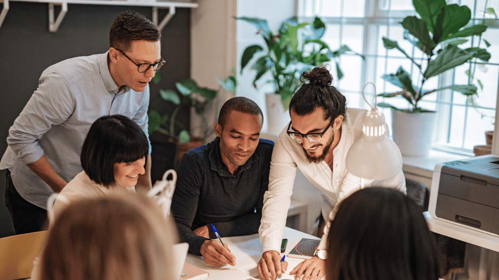 A group of people looking at a paper