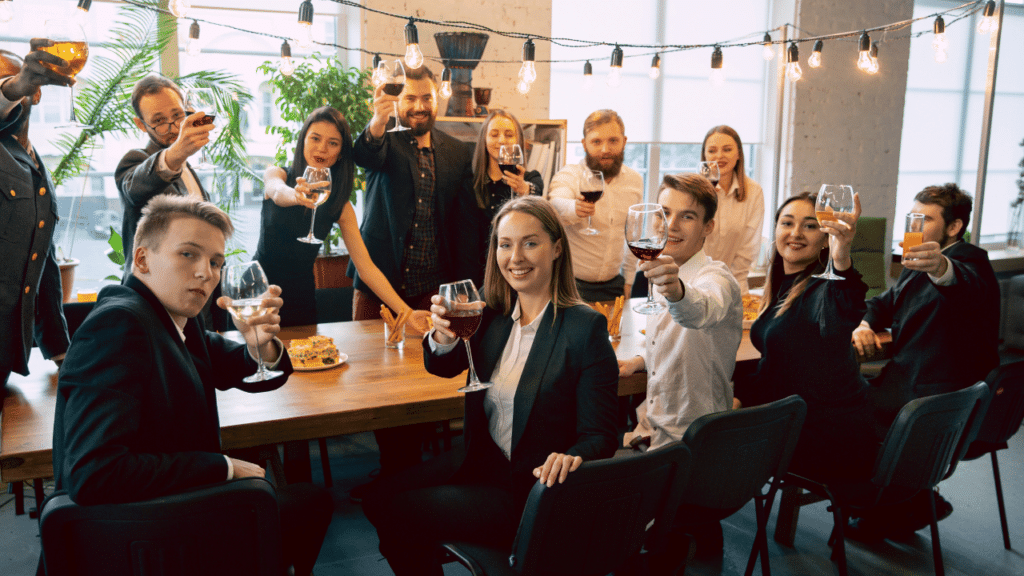 A group of people holding wine glasses