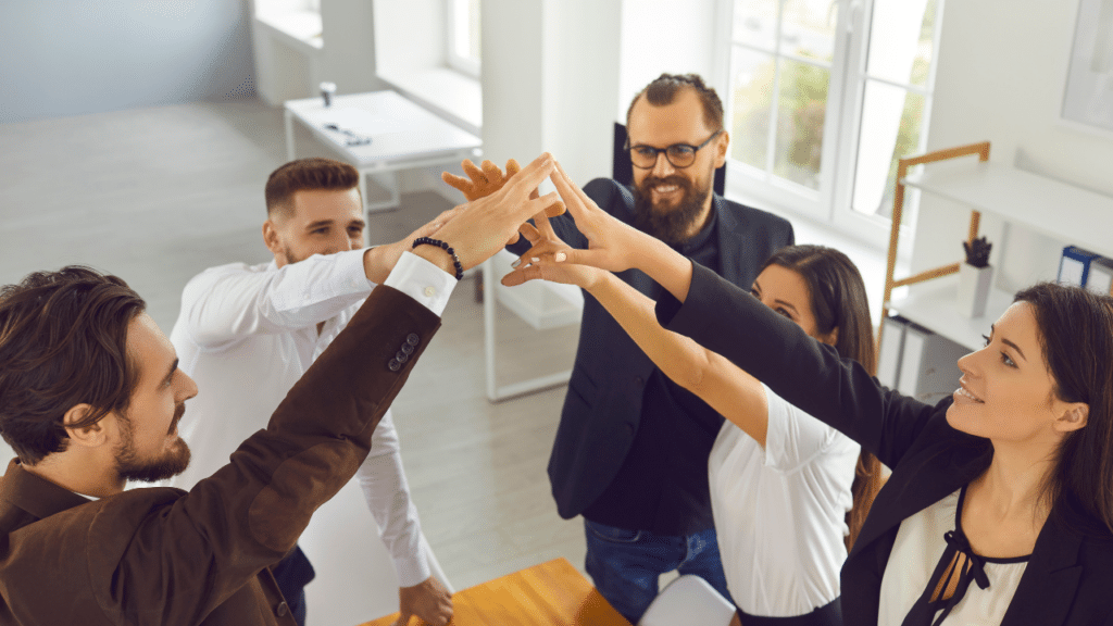 A group of people giving each other a high five