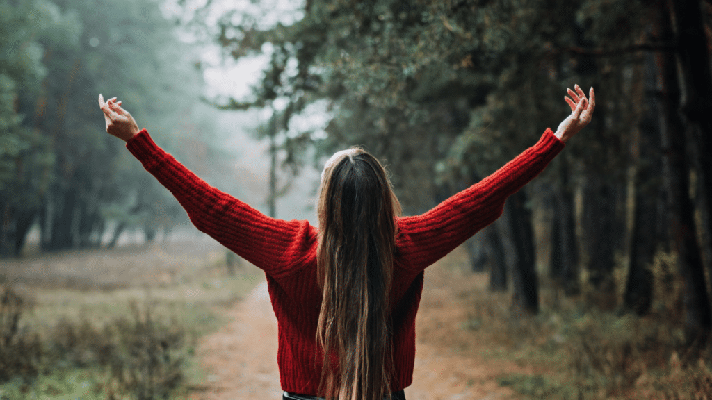 A woman with her arms raised in the air