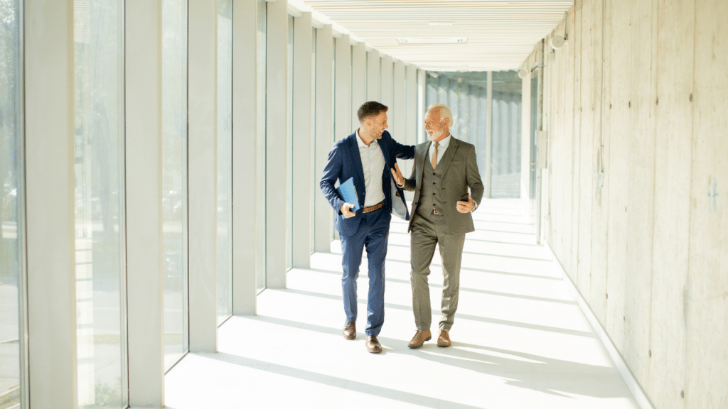 Two men in suits walking in a hallway