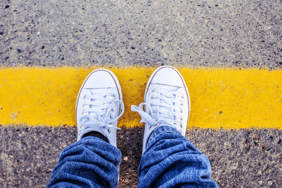 An image of a feet standing on a line depicting work boundaries