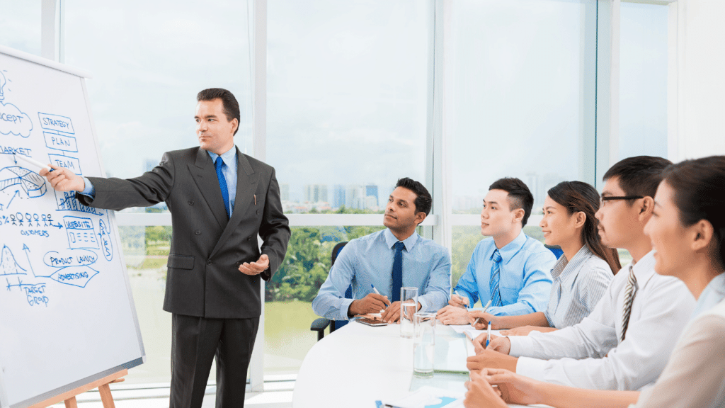 A man in a suit standing in front of a group of people