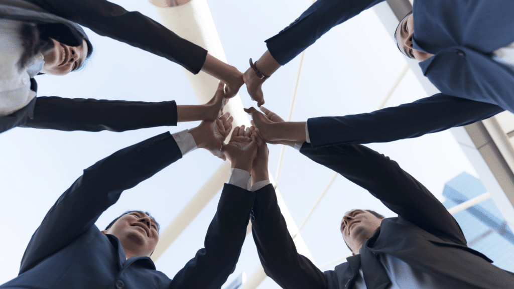 A group of people holding hands together