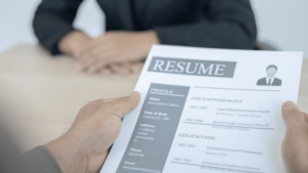 A hand holding a resume