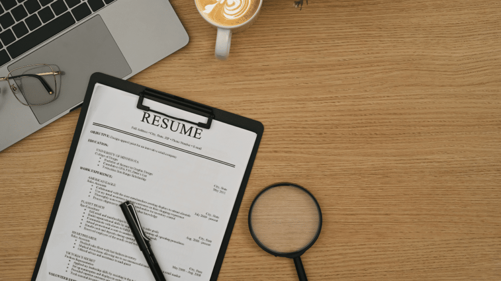 A magnifying glass and a clipboard on a desk